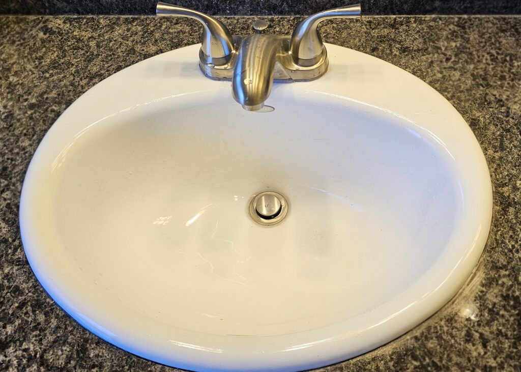 a white sink with a faucet