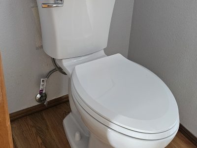 a toilet with a paper on the tank