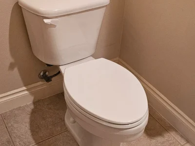 White toilet against beige wall