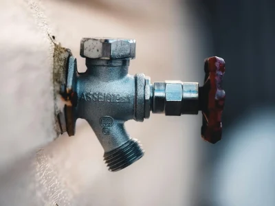 Metal hose bib on wall
