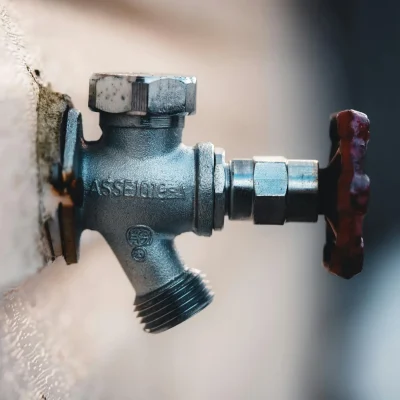 Metal hose bib on wall