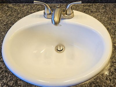 a white sink with a faucet