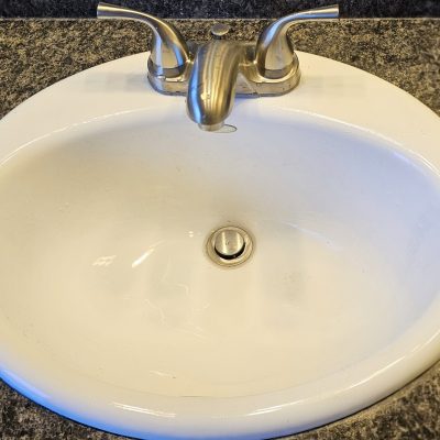 a white sink with a faucet